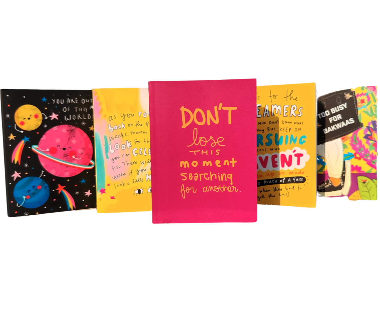 Set of colorful notebooks with various designs and text on a white background